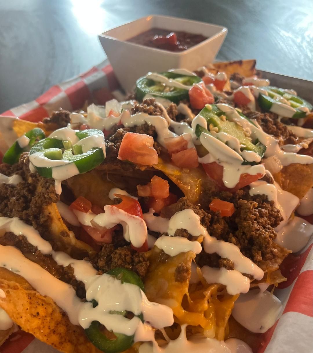 Loaded nachos piled with beef, cheese and fresh toppings