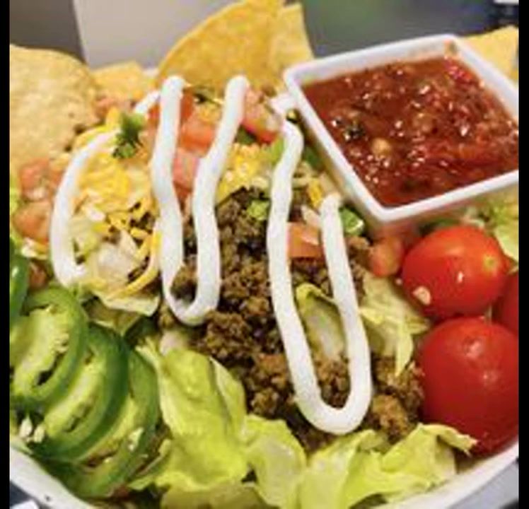 Taco salad with fresh vegetables and Keg sour cream