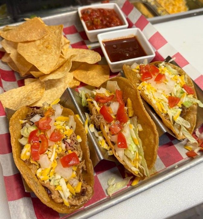 Crispy tacos with lettuce, cheese and tomato