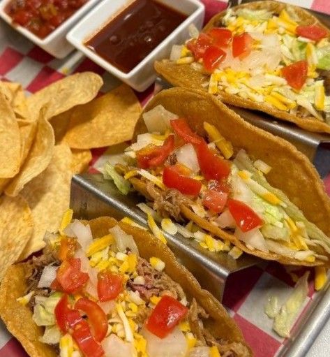 Street tacos with chips and salsa on checkered paper